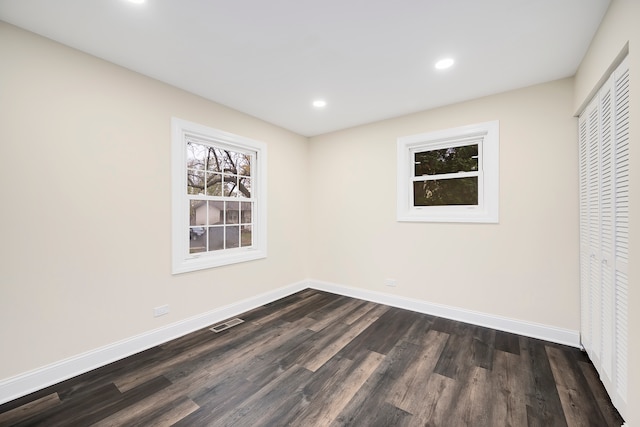 unfurnished room featuring dark wood-type flooring