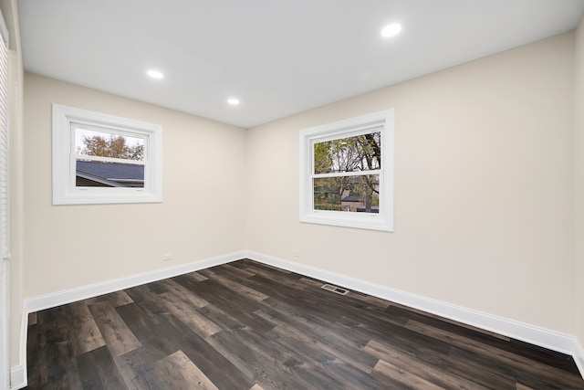 empty room with dark wood-type flooring