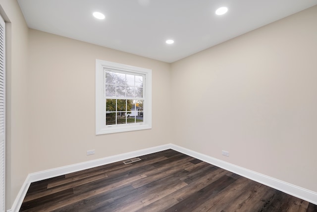 spare room with dark hardwood / wood-style flooring