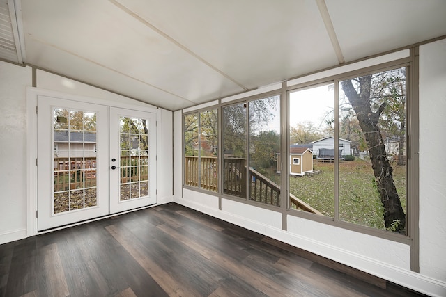 unfurnished sunroom featuring vaulted ceiling and french doors