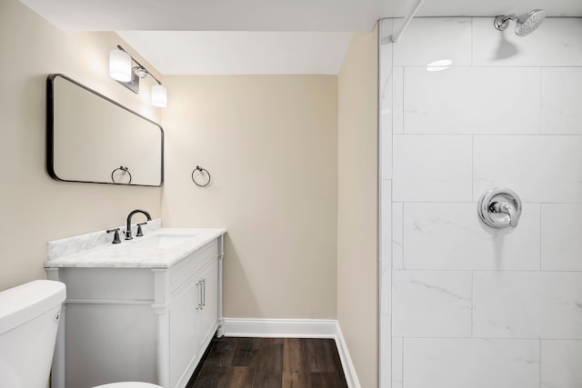 bathroom featuring toilet, vanity, and hardwood / wood-style floors