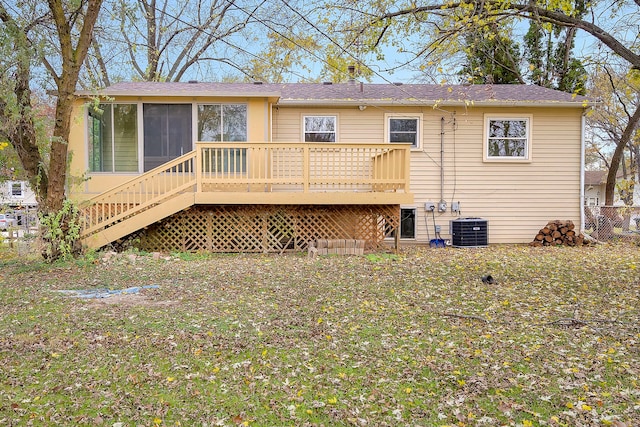 back of house with central AC, a sunroom, and a wooden deck