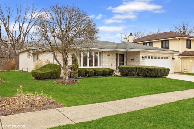 view of front of home featuring a garage and a front lawn