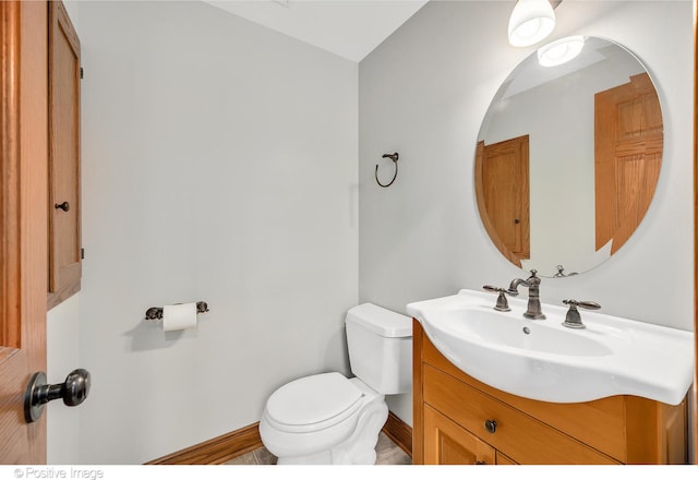 bathroom featuring toilet and vanity