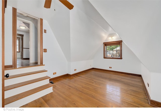 bonus room featuring lofted ceiling, hardwood / wood-style flooring, and ceiling fan