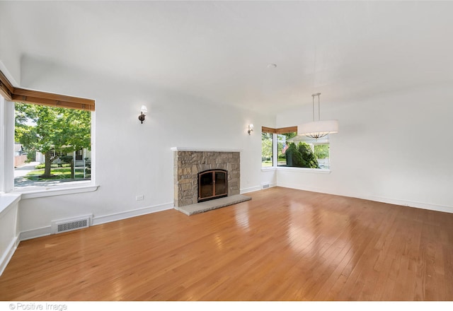 unfurnished living room featuring light hardwood / wood-style floors and a fireplace