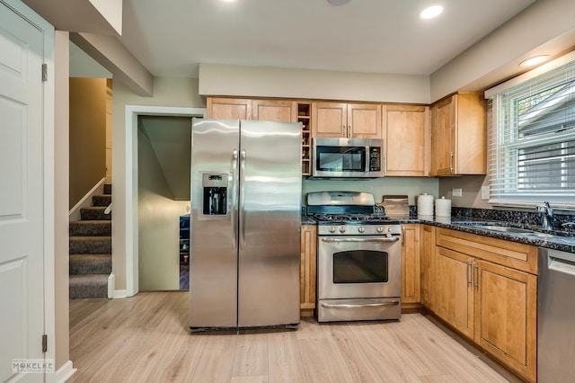 1019 N Webster St, Naperville, IL 60563 - kitchen with stainless steel appliances, light wood-style floors, a sink, recessed lighting, and dark stone countertops