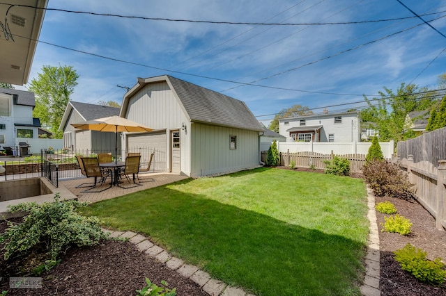 1019 N Webster St, Naperville, IL 60563 - view of yard featuring an outdoor structure, a detached garage, and a patio