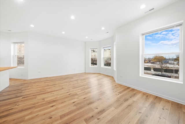 unfurnished living room featuring light hardwood / wood-style floors and a healthy amount of sunlight