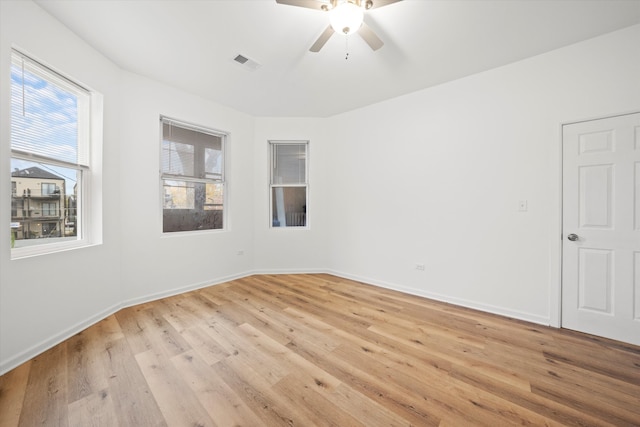 empty room featuring a wealth of natural light and light hardwood / wood-style floors