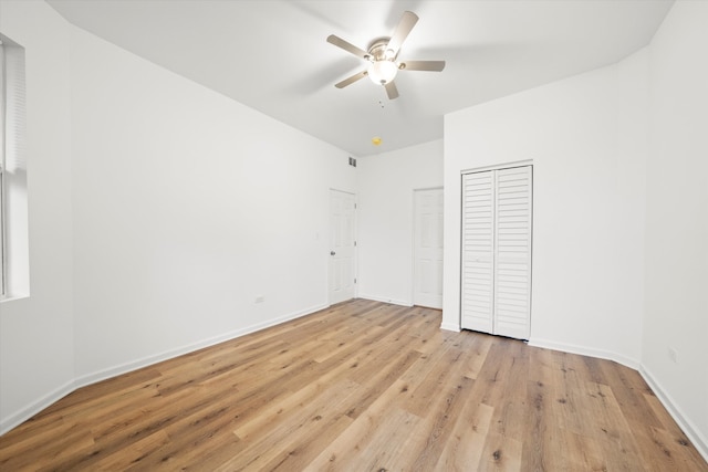 unfurnished bedroom with ceiling fan and light hardwood / wood-style floors