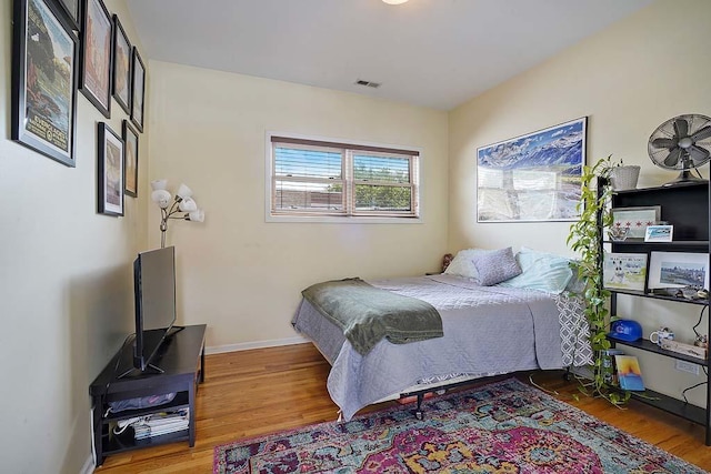 bedroom with hardwood / wood-style flooring