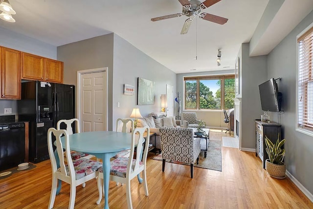 dining area with light hardwood / wood-style floors and ceiling fan