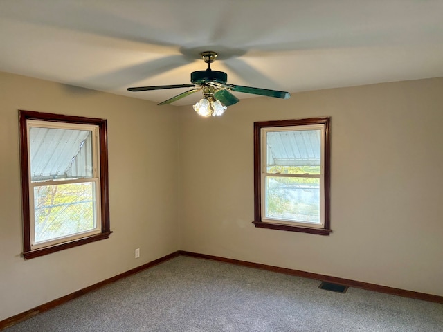 unfurnished room featuring ceiling fan and carpet