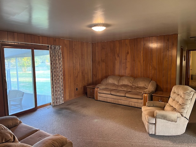 carpeted living room with wood walls