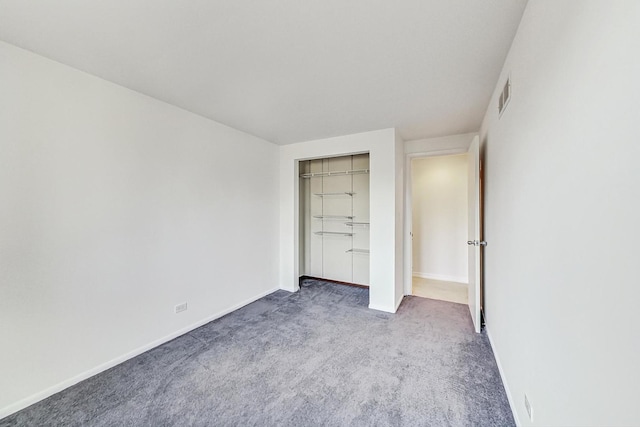 unfurnished bedroom with carpet flooring and a closet