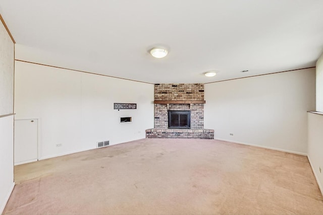 unfurnished living room with a brick fireplace and light carpet