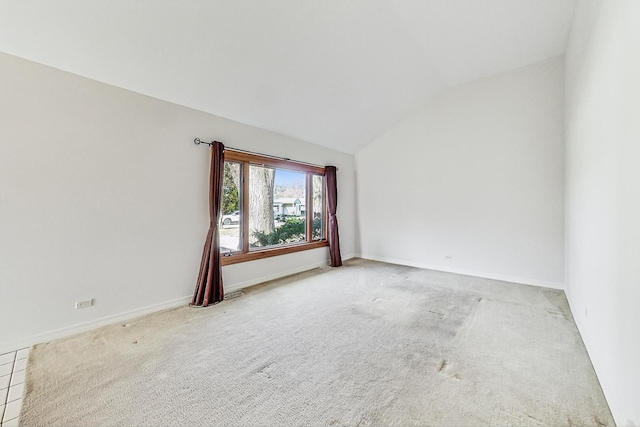 unfurnished room with lofted ceiling and carpet floors