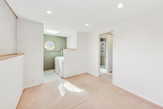 washroom with light colored carpet and washing machine and clothes dryer