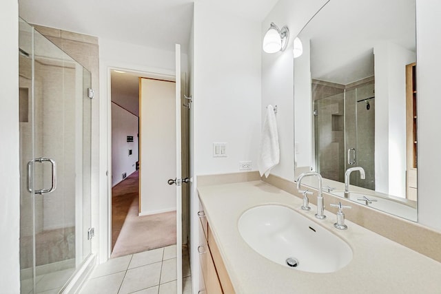 bathroom with vanity, a shower with shower door, and tile patterned floors