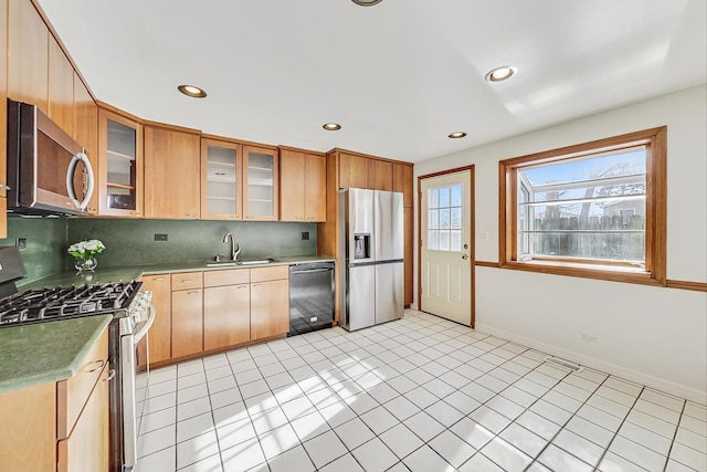 kitchen with tasteful backsplash, stainless steel appliances, sink, and light tile patterned floors