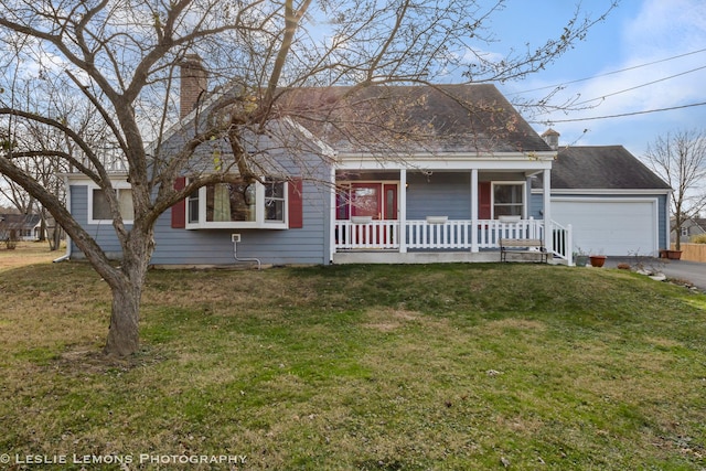 view of front of house with covered porch, a garage, and a front lawn