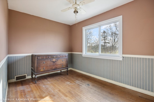 spare room with ceiling fan and wood-type flooring