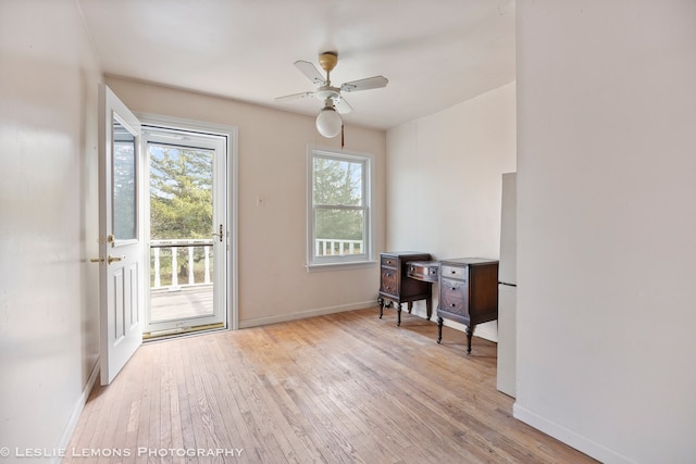 doorway featuring ceiling fan and light hardwood / wood-style floors