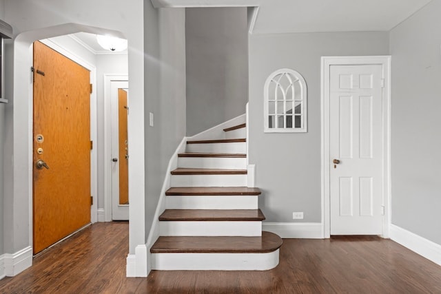 stairs with crown molding and hardwood / wood-style floors