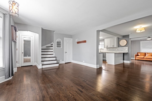 unfurnished living room with dark hardwood / wood-style floors