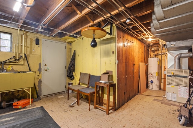 basement with sink, heating unit, and water heater