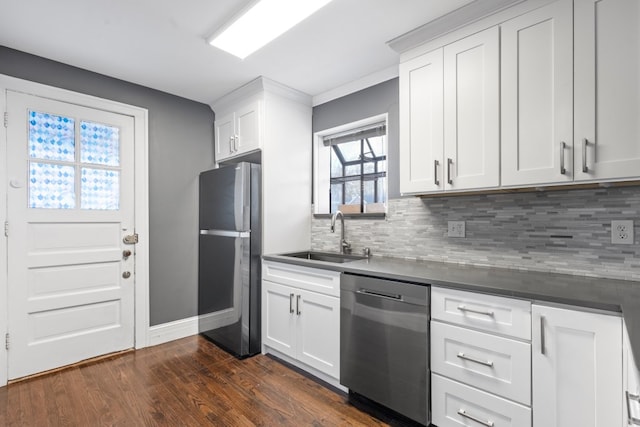 kitchen featuring stainless steel appliances, white cabinetry, and sink