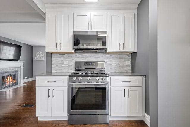 kitchen featuring backsplash, dark hardwood / wood-style flooring, white cabinets, and stainless steel appliances