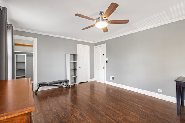 interior space with crown molding, ceiling fan, and dark wood-type flooring