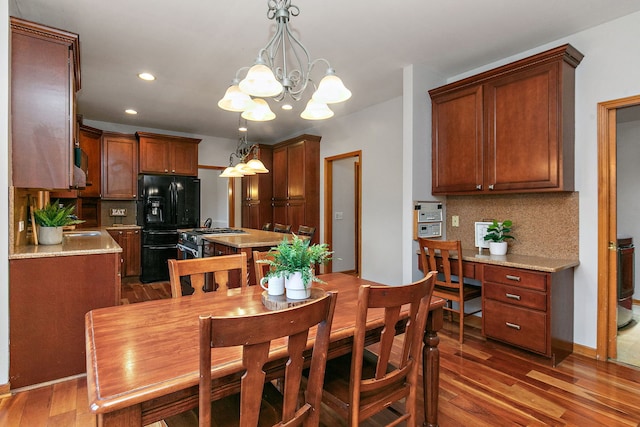 dining space featuring a notable chandelier and dark hardwood / wood-style flooring