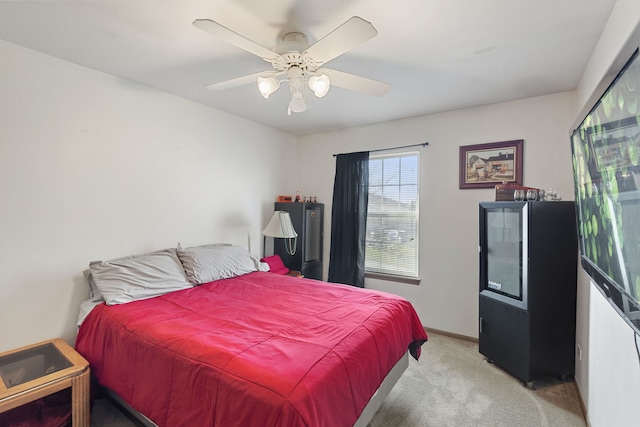 bedroom featuring light carpet and ceiling fan