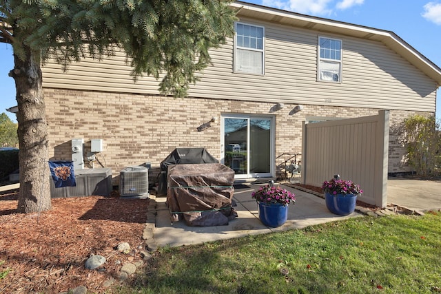 back of house with central air condition unit and a patio area