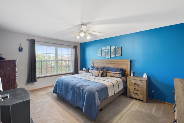 bedroom with ceiling fan and light colored carpet