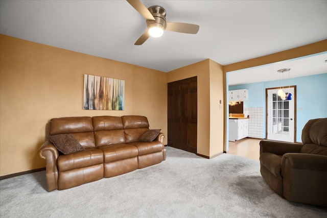 living room with ceiling fan and carpet