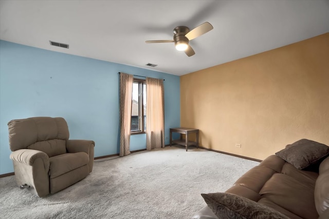 living area featuring ceiling fan and light colored carpet