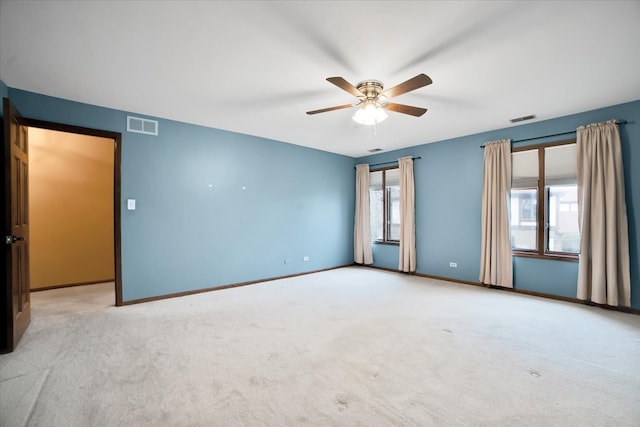 empty room featuring light colored carpet and ceiling fan