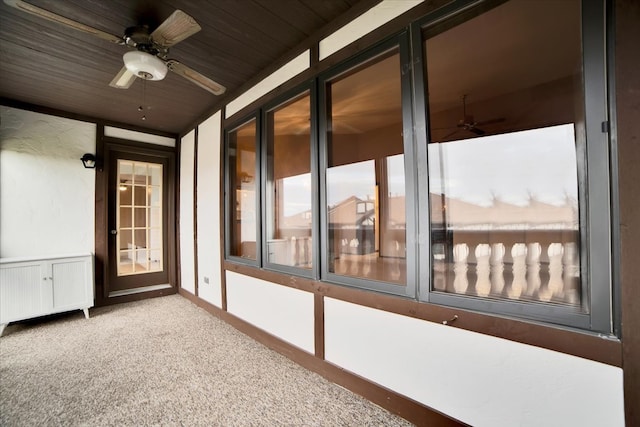 unfurnished sunroom featuring ceiling fan and wood ceiling