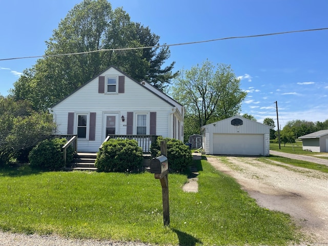 view of front of home featuring an outbuilding, a garage, and a front yard