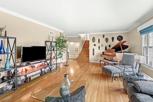 living room featuring wood-type flooring and crown molding