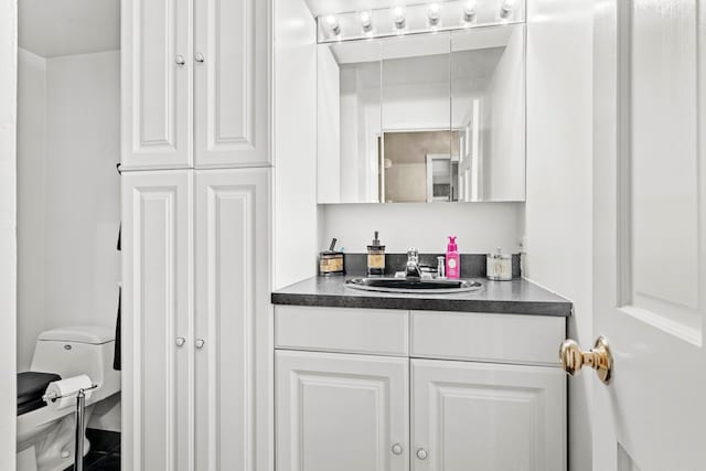 bathroom featuring vanity and toilet