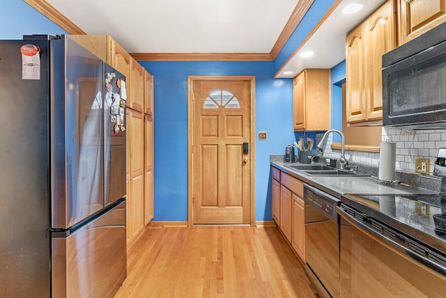 kitchen with decorative backsplash, light wood-type flooring, crown molding, sink, and black appliances