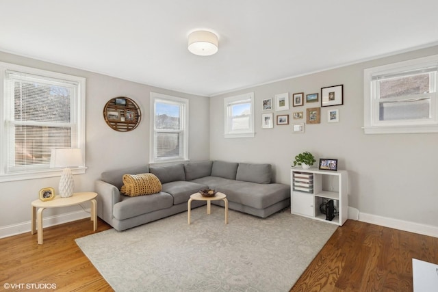 living area with light wood-style flooring and baseboards