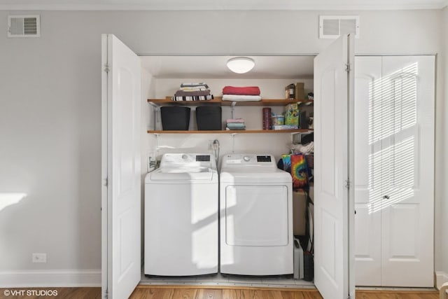 laundry area with washer and dryer, laundry area, visible vents, and plenty of natural light