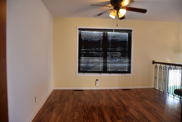 spare room featuring dark hardwood / wood-style floors and ceiling fan