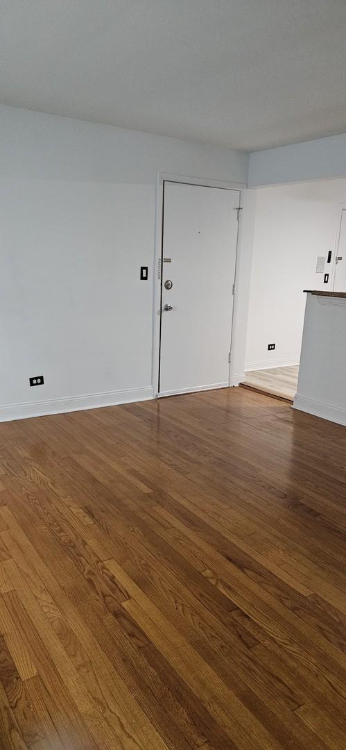 unfurnished room with hardwood / wood-style floors